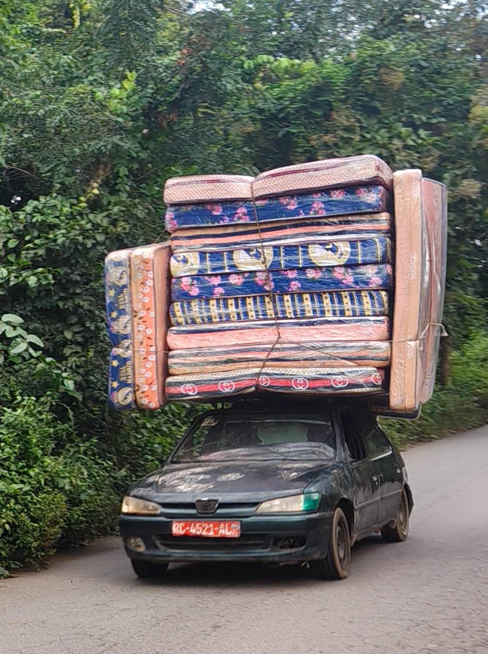 Twelve mattresses on top of a single car