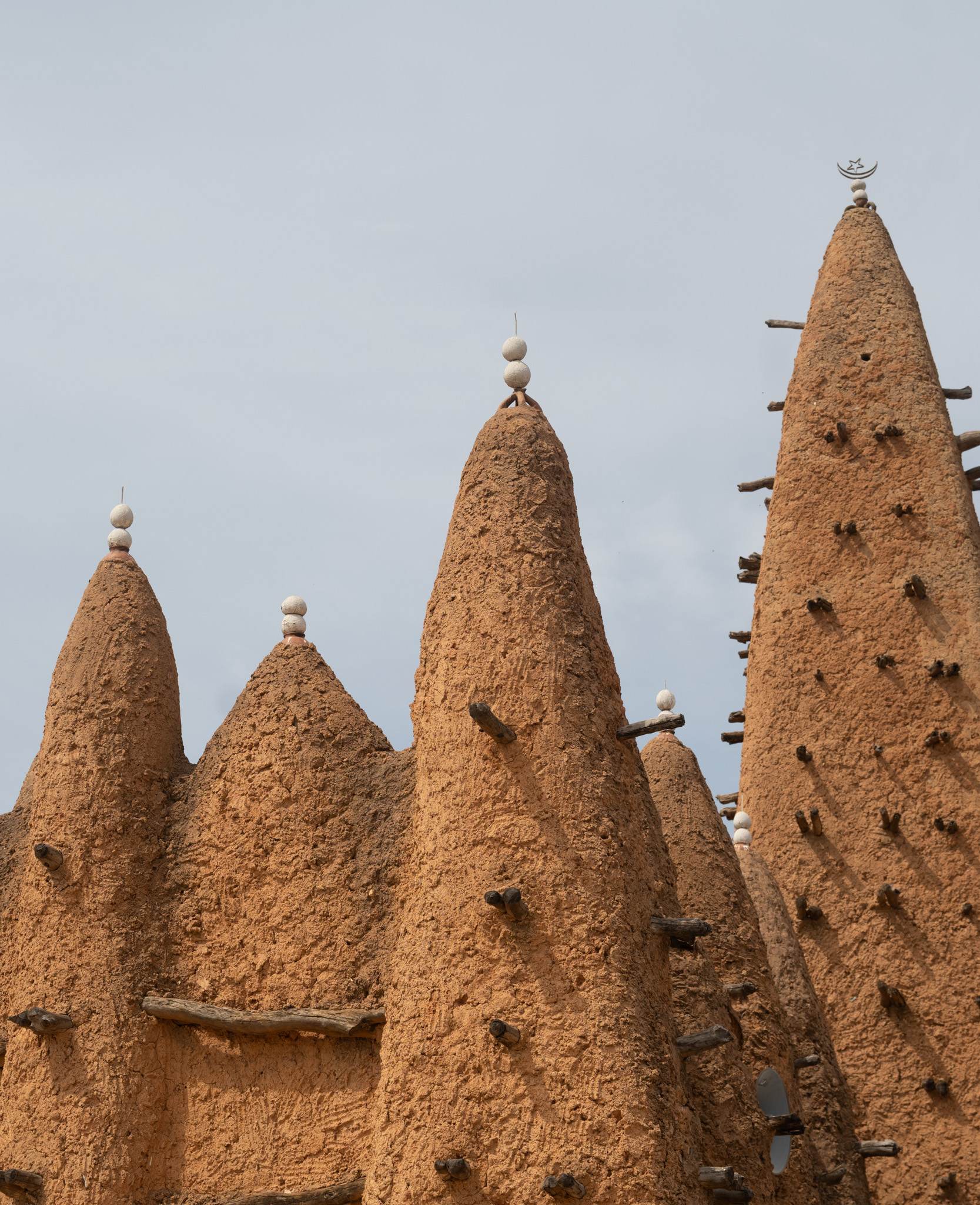 The minarets of this mosque used to be adorned with ostrich eggs, but now they use coconuts painted white