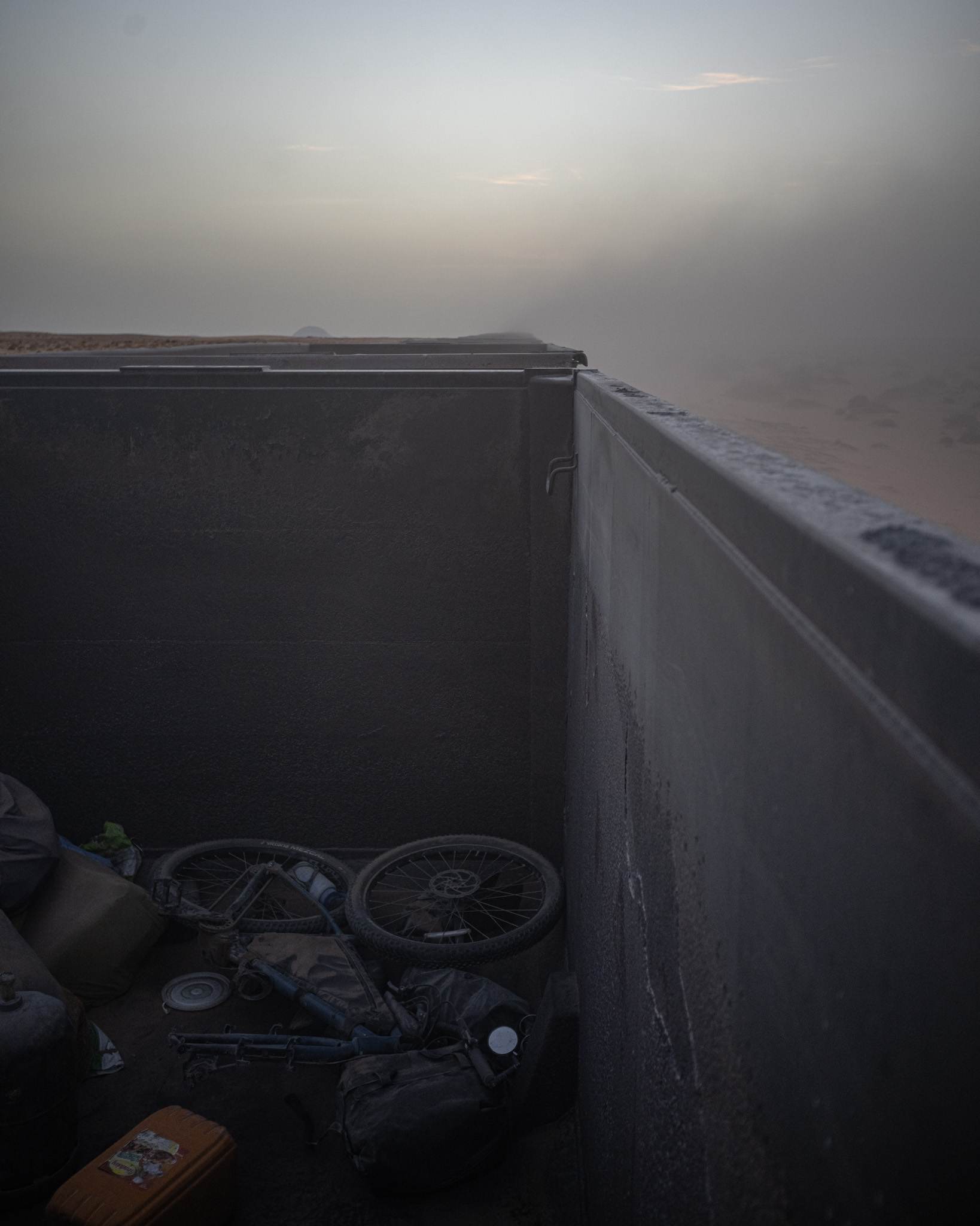 My bicycle dismantled and full of iron ore inside the wagon